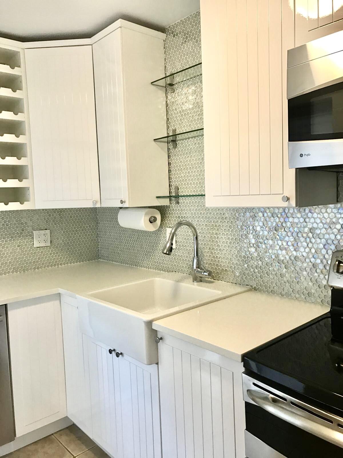 1439 South Ocean Boulevard, Unit 303 Lauderdale-by-the-Sea, FL 33062 - Photo 16 of 31 a kitchen with a sink cabinets and a window