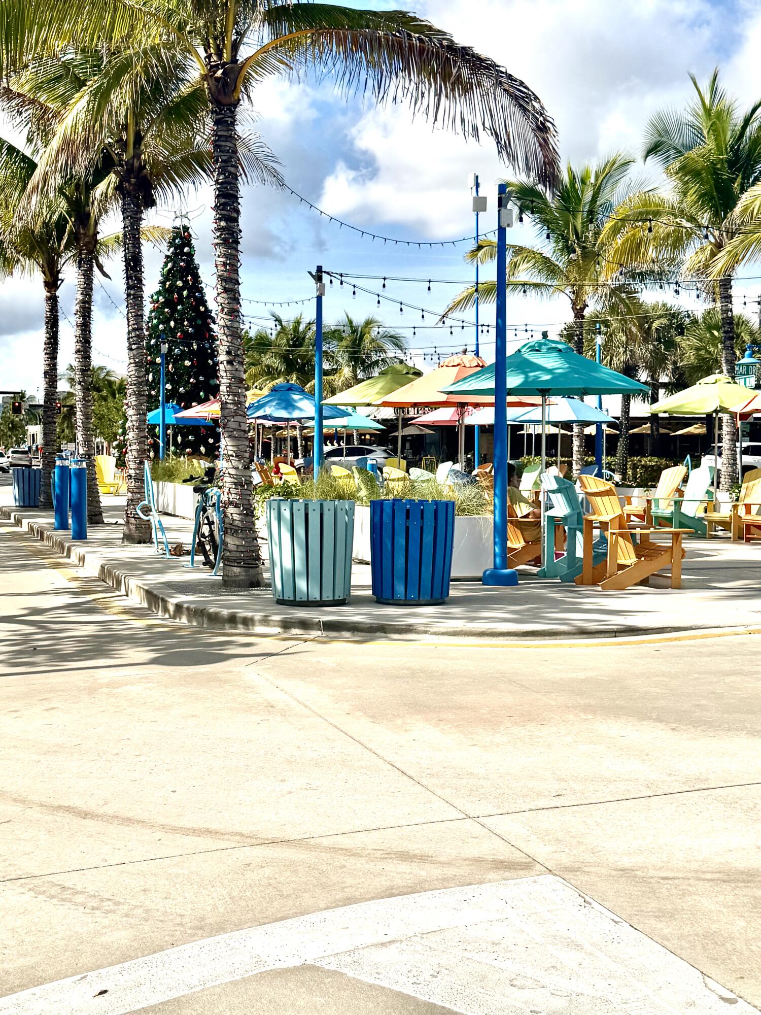 1439 South Ocean Boulevard, Unit 303 Lauderdale-by-the-Sea, FL 33062 - Photo 30 of 31 a view of a swimming pool with a lawn chairs under palm trees