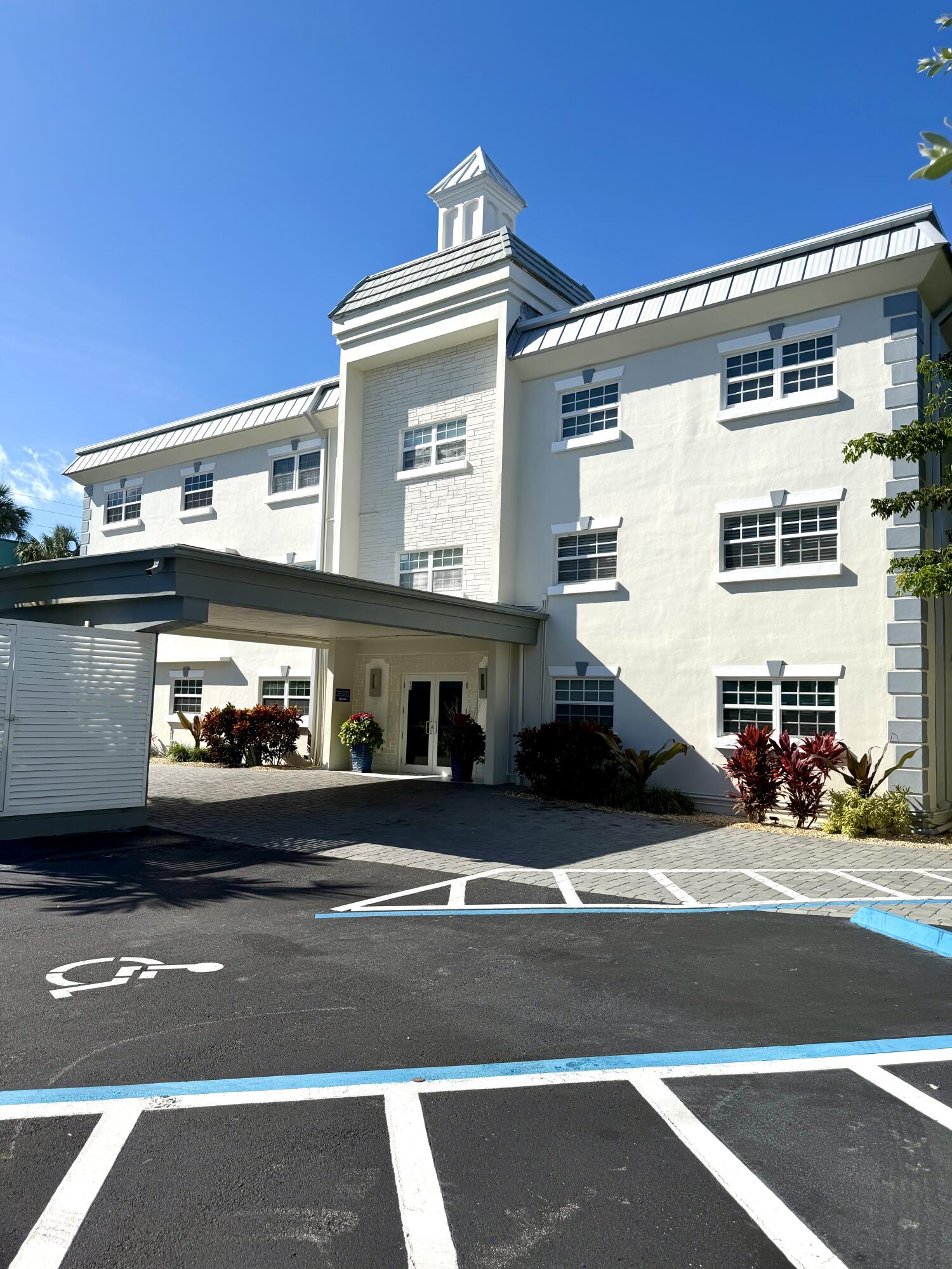 1439 South Ocean Boulevard, Unit 303 Lauderdale-by-the-Sea, FL 33062 - Photo 4 of 31 a view of a building and car parked