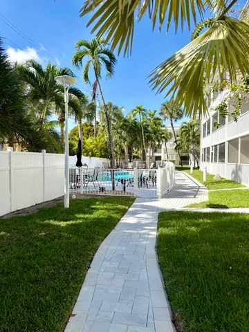a view of a swimming pool with a garden and trees