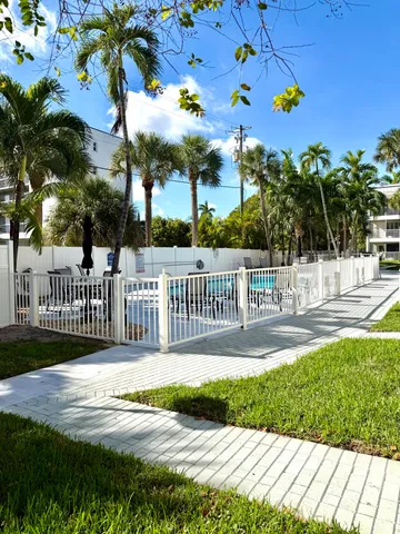 a view of a house with a porch and a yard