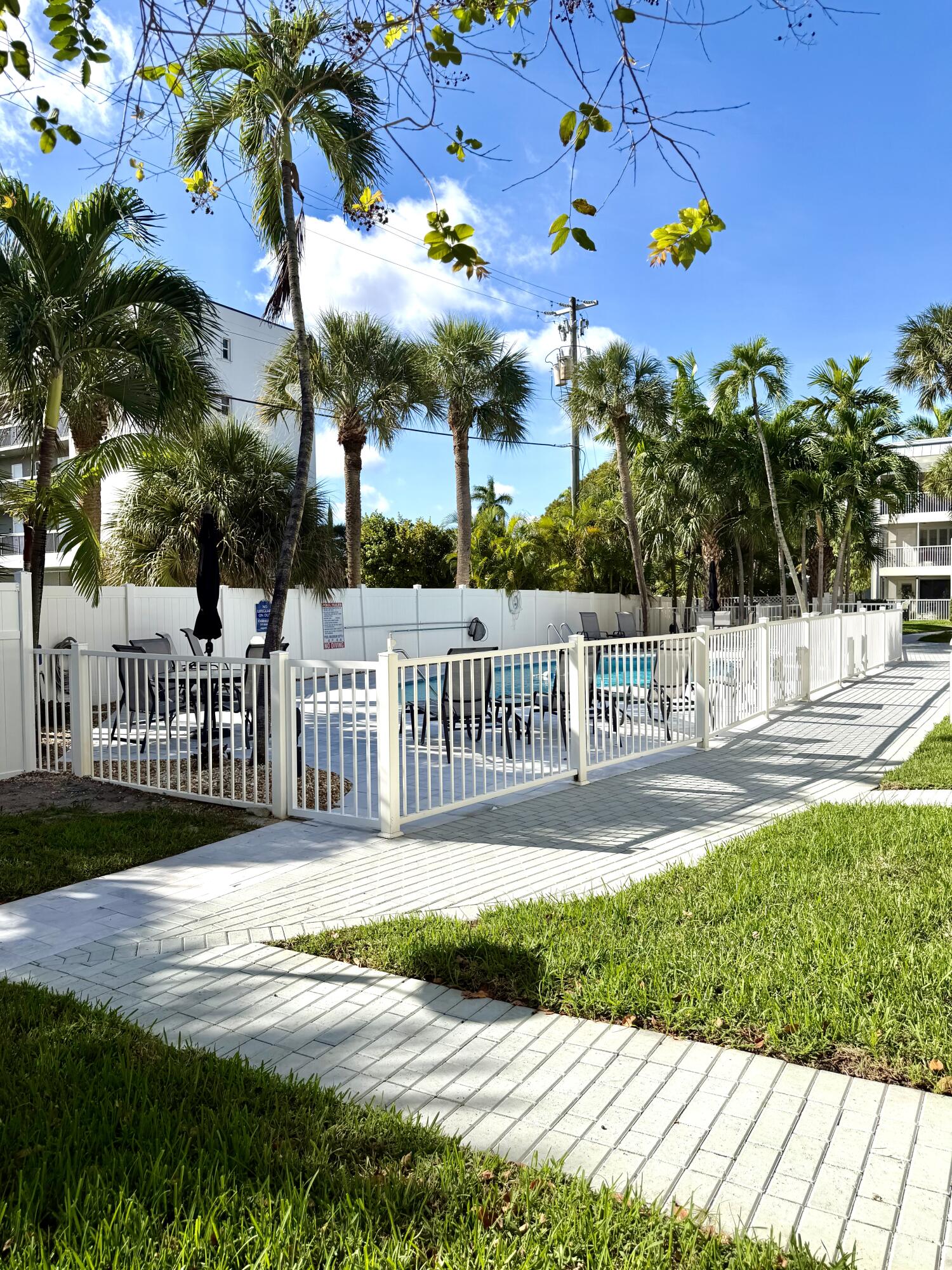 1439 South Ocean Boulevard, Unit 303 Lauderdale-by-the-Sea, FL 33062 - Photo 6 of 31 a view of a house with a porch and a yard