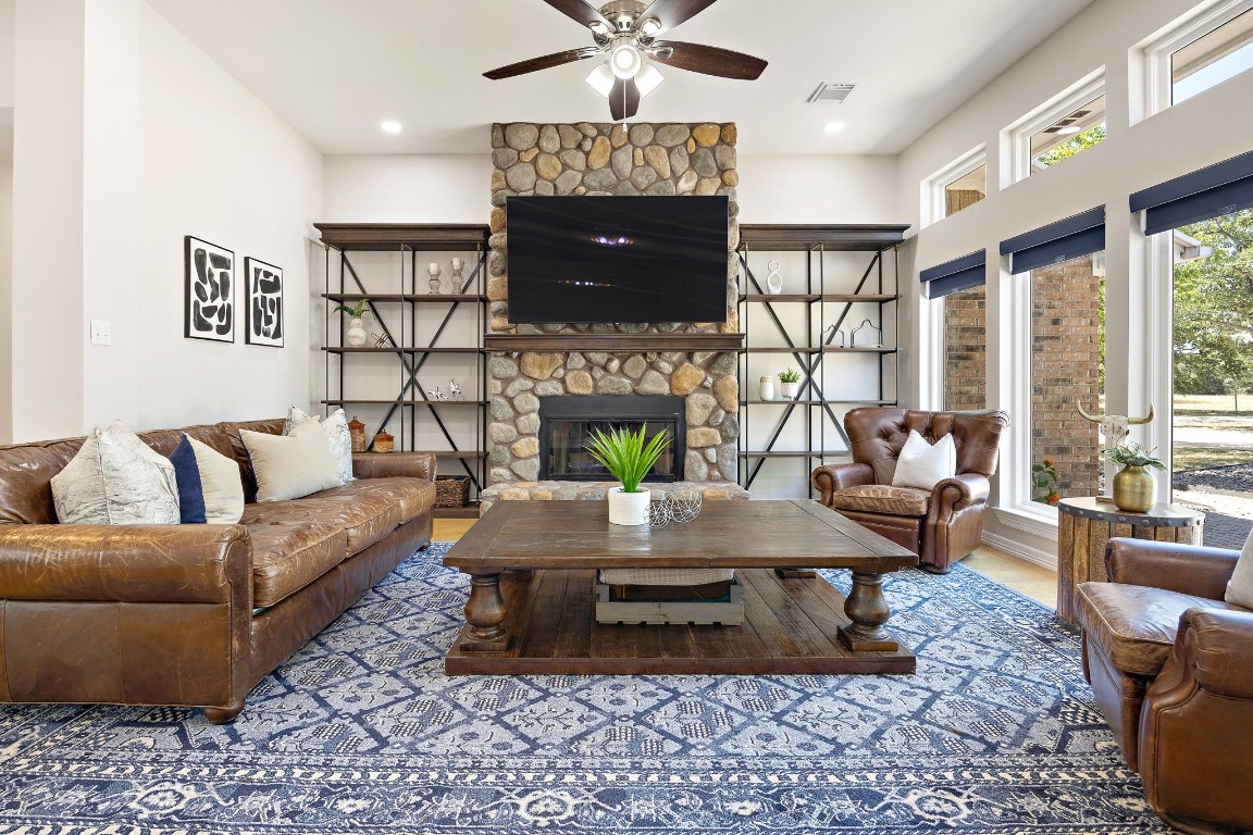 The large Living Room features a large wood-burning stone fireplace.