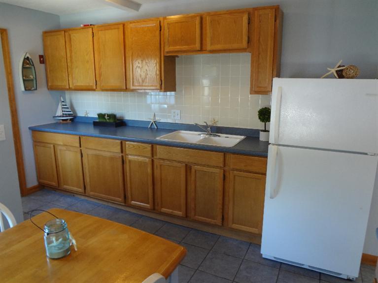 138 Spring Street Hyannis, MA 02601 - Photo 1 of 12 a kitchen with stainless steel appliances granite countertop a refrigerator sink and cabinets