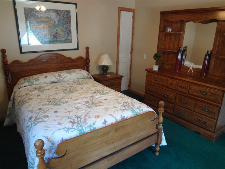 138 Spring Street Hyannis, MA 02601 - Photo 3 of 12 a bedroom with a bed and a mirror on dresser