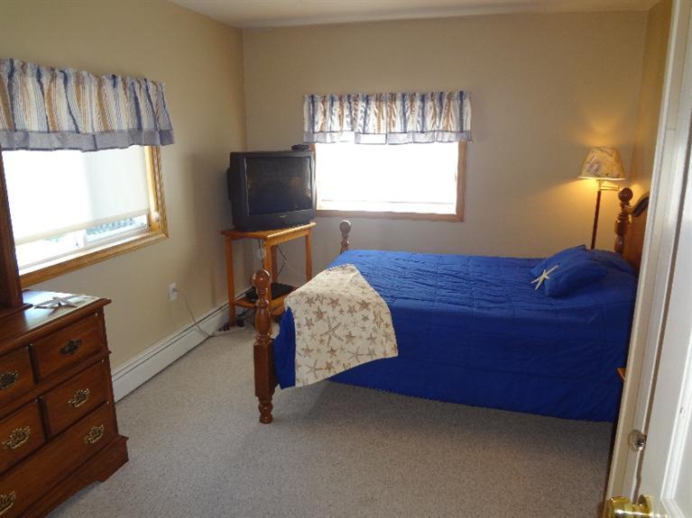 138 Spring Street Hyannis, MA 02601 - Photo 4 of 12 a bedroom with a bed window and wooden floor