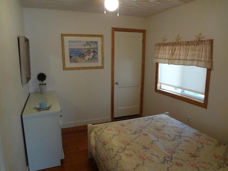 138 Spring Street Hyannis, MA 02601 - Photo 6 of 12 a bedroom with a bed and a window
