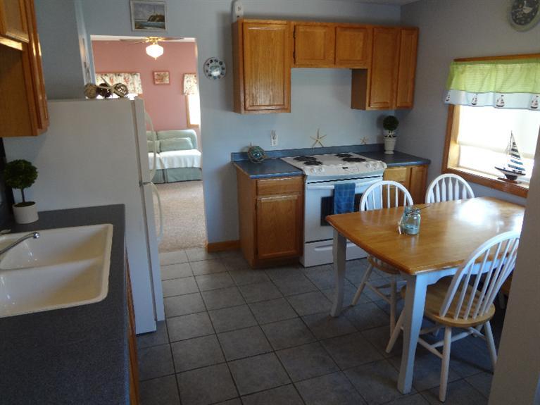 138 Spring Street Hyannis, MA 02601 - Photo 8 of 12 a kitchen with a sink cabinets and window