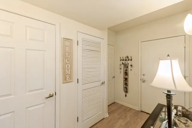 an entryway with wooden floor and cabinet