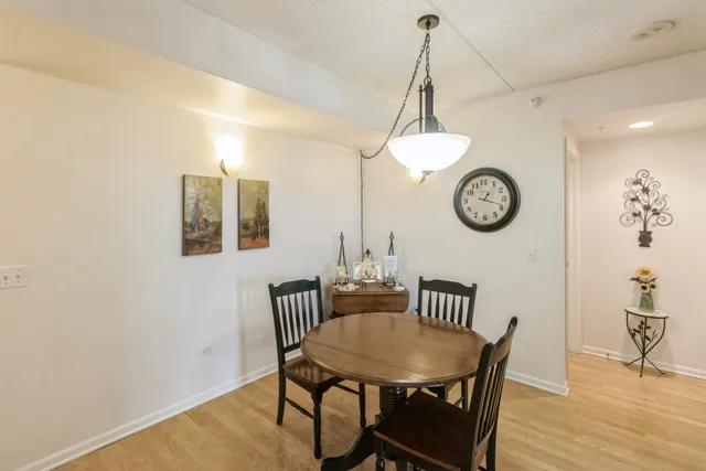 a view of a dining room with a table and chairs