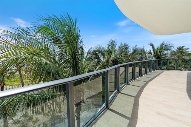 a balcony with view of palm trees