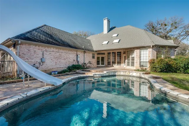 a swimming pool view with a outdoor seating