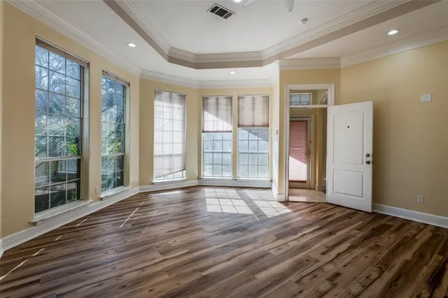 a large kitchen with stainless steel appliances granite countertop a stove and a wooden floors