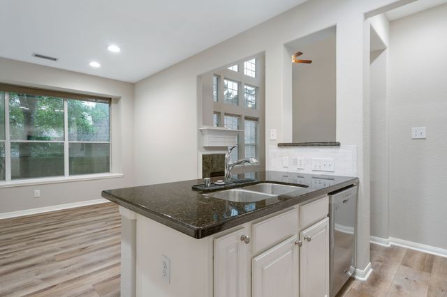 a kitchen with granite countertop a sink and a window