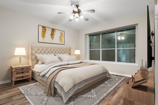 a bedroom with a bed and a window