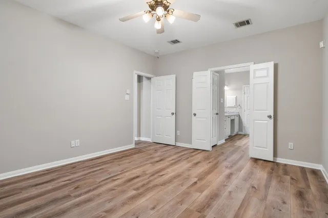 a view of an empty room with wooden floor