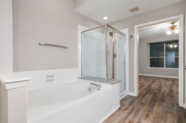 a bathroom with a bathtub and a shower