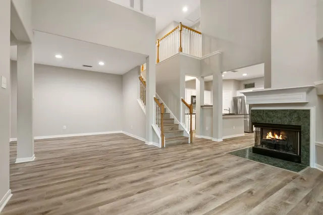 a view of a livingroom with wooden floor and a fireplace