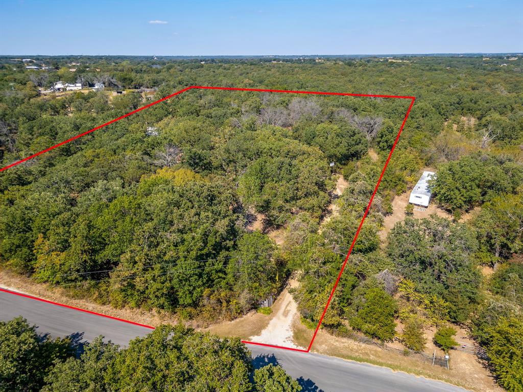 436 Luke Road Springtown, TX 76082 - Photo 38 of 39 Aerial view of property's location featuring property parcel outlined and a forest