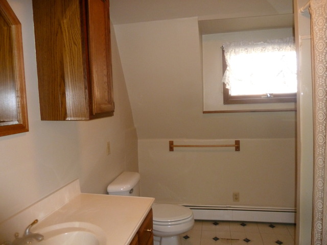 22968 West Grimm Road Antioch, IL 60002 - Photo 18 of 24 a white toilet sitting next to a bathroom sink and vanity