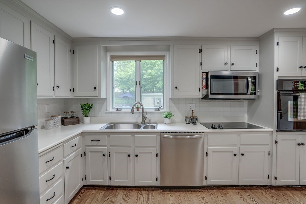 11 Avalon Road Reading, MA 01867 - Photo 12 of 31 a kitchen with cabinets appliances a sink and a window