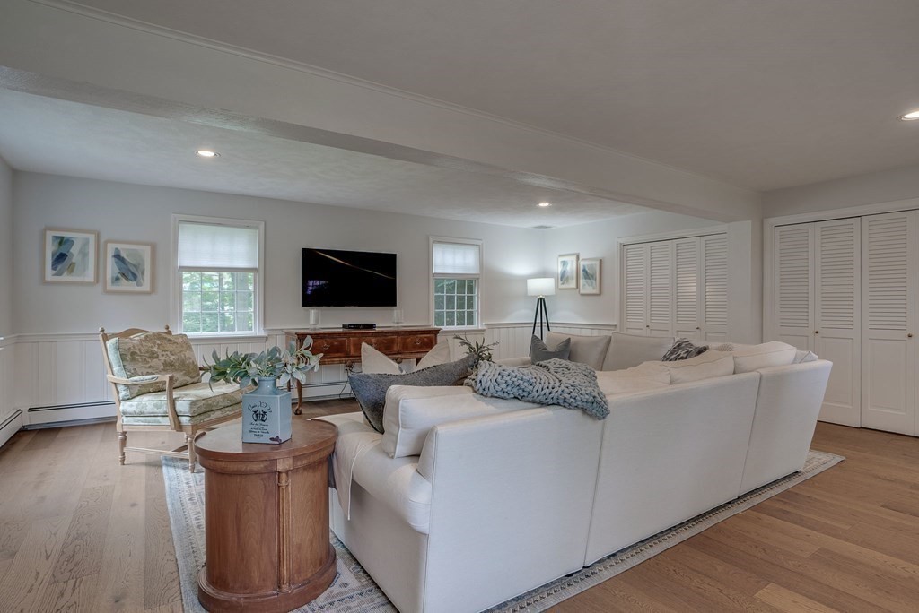 11 Avalon Road Reading, MA 01867 - Photo 19 of 31 a living room with couches and a flat screen tv
