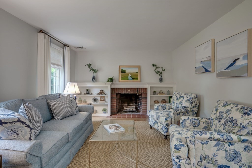11 Avalon Road Reading, MA 01867 - Photo 23 of 31 a living room with furniture and a fireplace