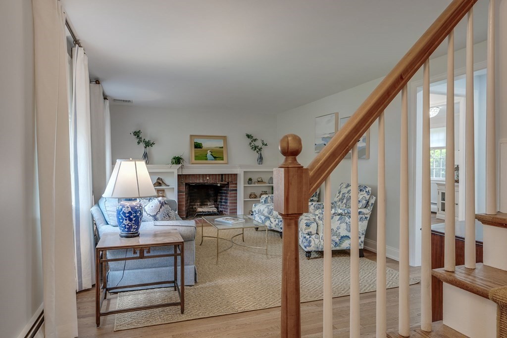 11 Avalon Road Reading, MA 01867 - Photo 28 of 31 a living room with furniture a fireplace and a large window