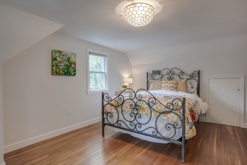 11 Avalon Road Reading, MA 01867 - Photo 30 of 31 a bedroom with a bed and wooden floor