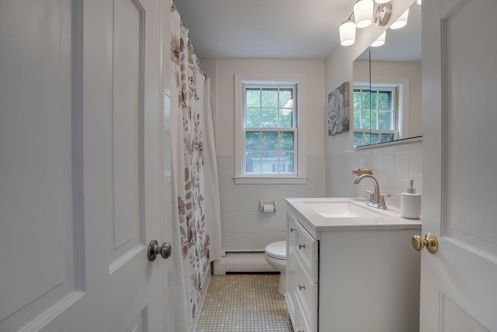 11 Avalon Road Reading, MA 01867 - Photo 31 of 31 a bathroom with a sink vanity granite and a mirror