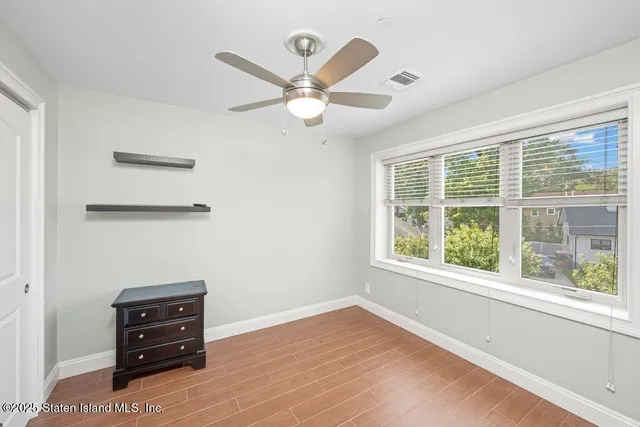 a view of a livingroom with furniture and a window