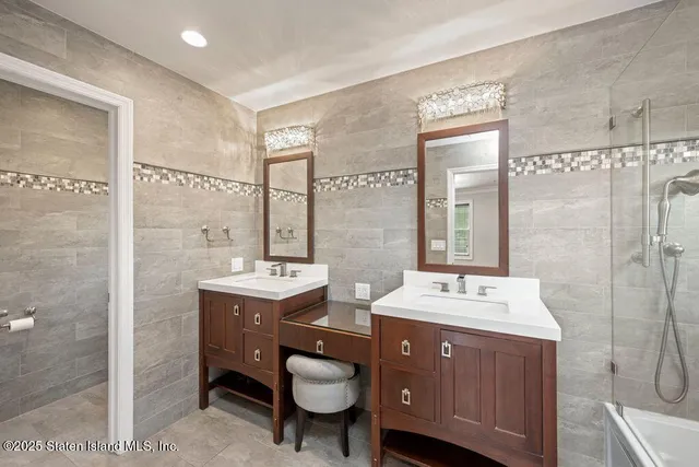 a bathroom with a double vanity sink mirror and toilet