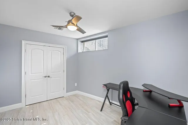 a workspace with wooden floor and a chair
