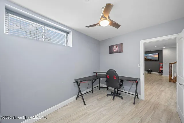 a view of a deck with wooden floor and fence with a floor to ceiling window