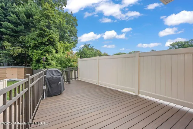 a backyard of a house with a garden and deck