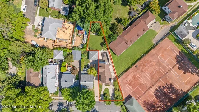 an aerial view of multiple houses with yard