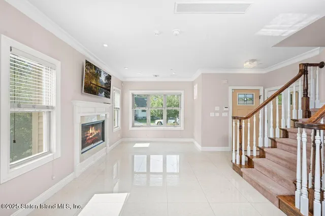 a view of an empty room with a fireplace and a window