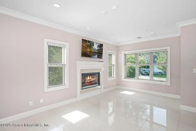 a view of a livingroom with a fireplace and a window