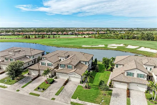 an aerial view of a house with a garden and trees