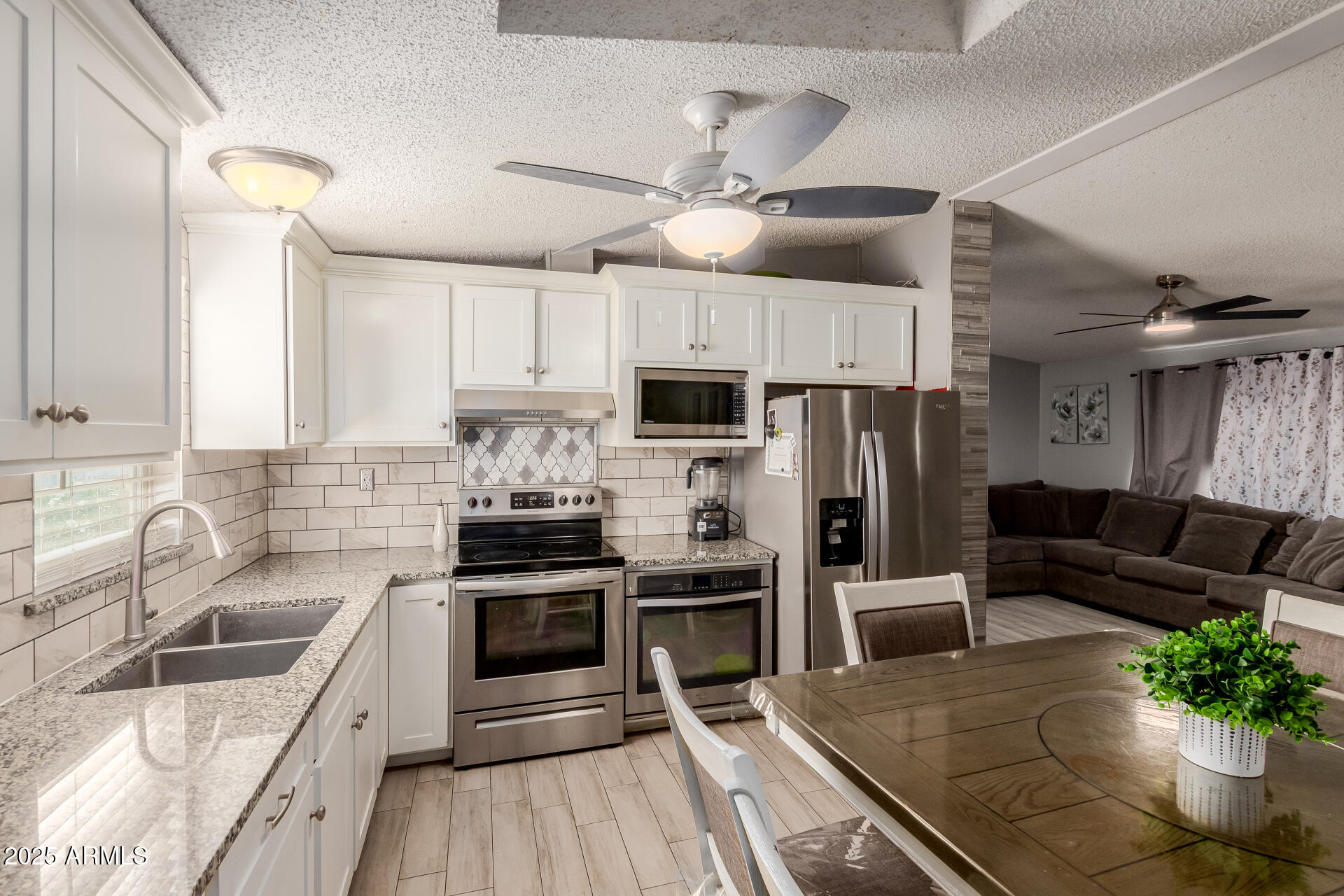 555 West Warner Road, Unit 139 Chandler, AZ 85225 - Photo 6 of 21 a kitchen with granite countertop a refrigerator a sink dishwasher stove and oven