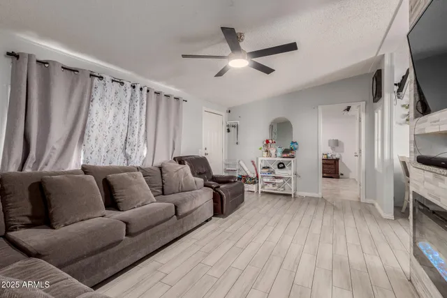 a living room with furniture and a wooden floor
