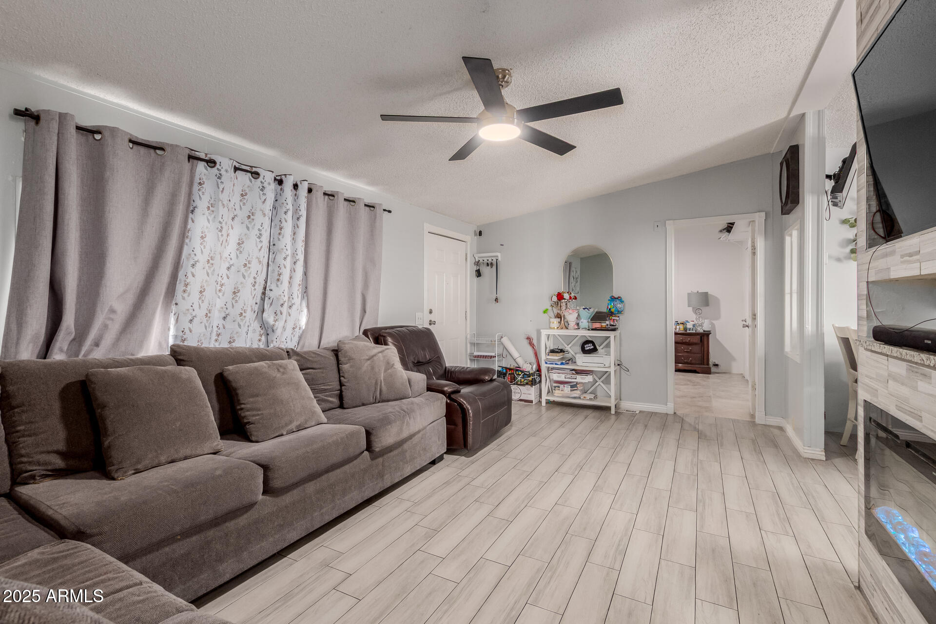 555 West Warner Road, Unit 139 Chandler, AZ 85225 - Photo 8 of 21 a living room with furniture and a wooden floor