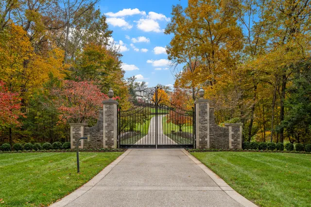 a view of a pathway with a wrought fence