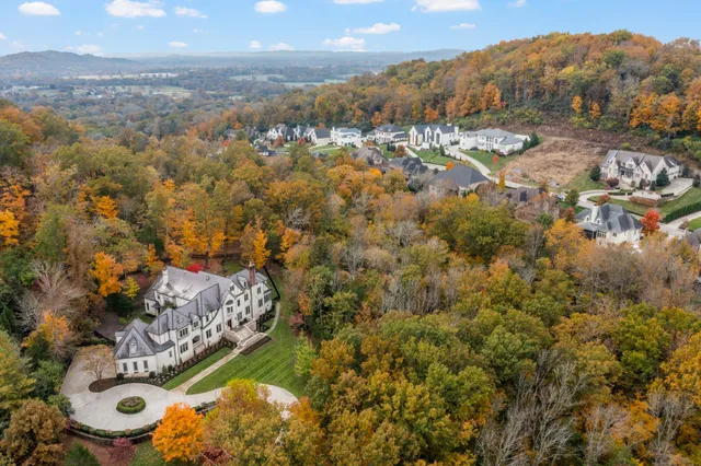 a living room with fireplace furniture and a large window