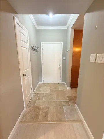 view of a hallway with wooden floor and a bathroom
