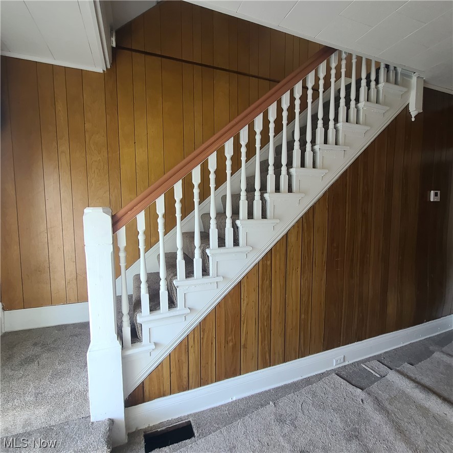 854 National Road Bridgeport, OH 43912 - Photo 7 of 27 Stairway featuring wooden walls and light carpet