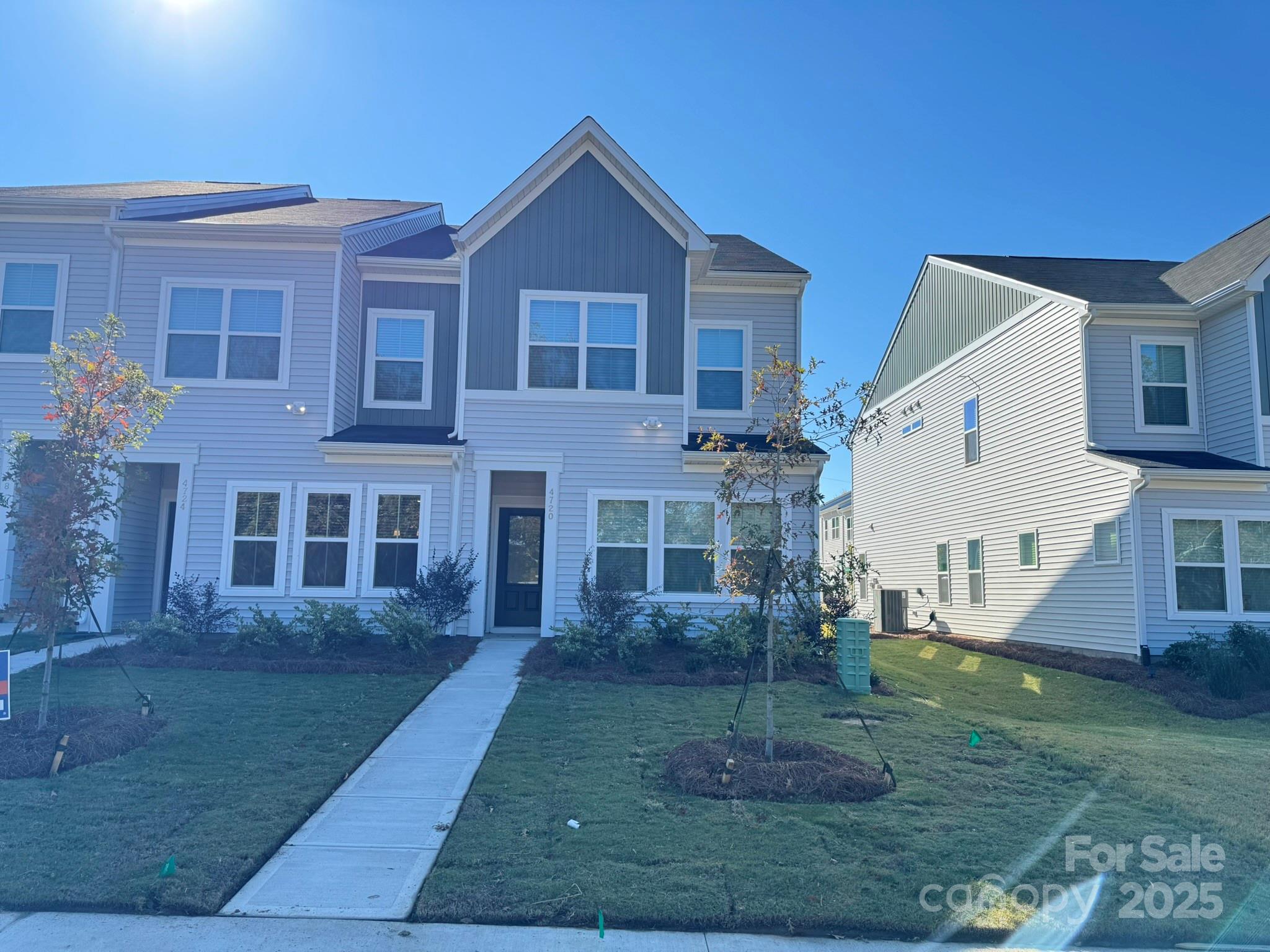 a view of a big house with a yard