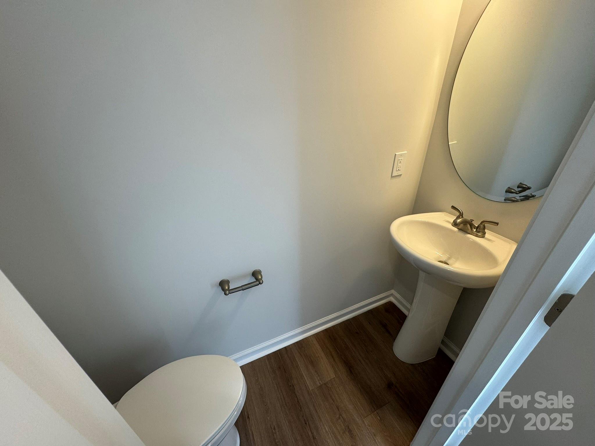 4720 Lakeview Road, Unit 12 Charlotte, NC 28216 - Photo 13 of 41 a bathroom with a sink mirror and toilet