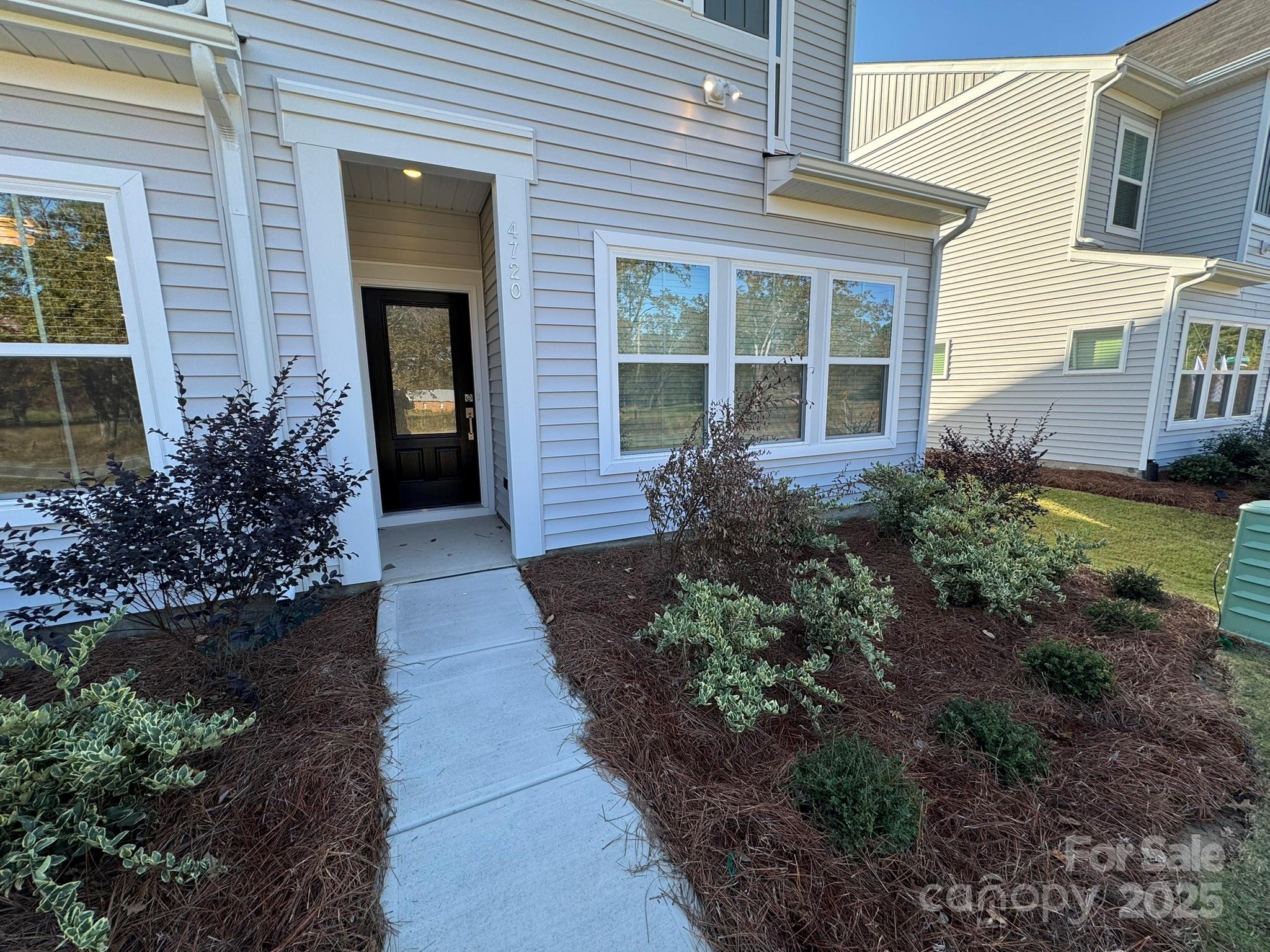 4720 Lakeview Road, Unit 12 Charlotte, NC 28216 - Photo 3 of 41 a view of a house with potted plants