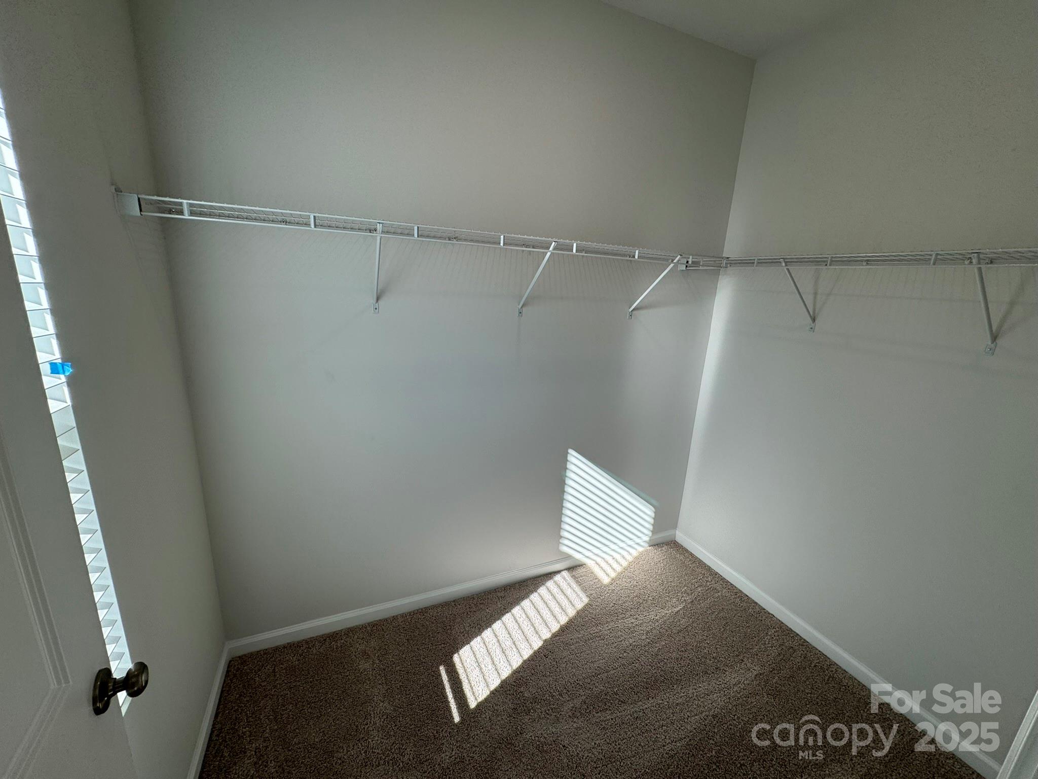 4720 Lakeview Road, Unit 12 Charlotte, NC 28216 - Photo 33 of 41 a view of a room with racks on the wall